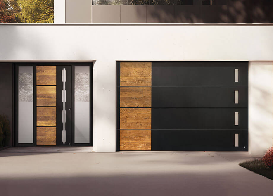 Modern garage doors by Access Garage Doors with wood and black panel design